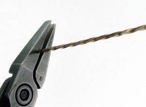 a pair of pliers hanging from a rope with one end cut off by the other