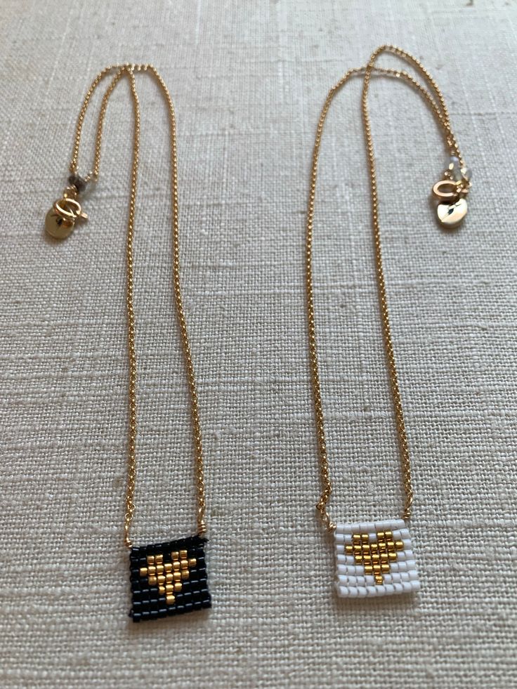 two necklaces that have been made to look like pixelated objects on them, one is