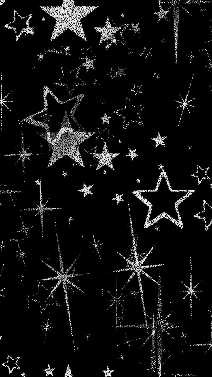 black and white photograph of stars in the night sky with sparkles on each side