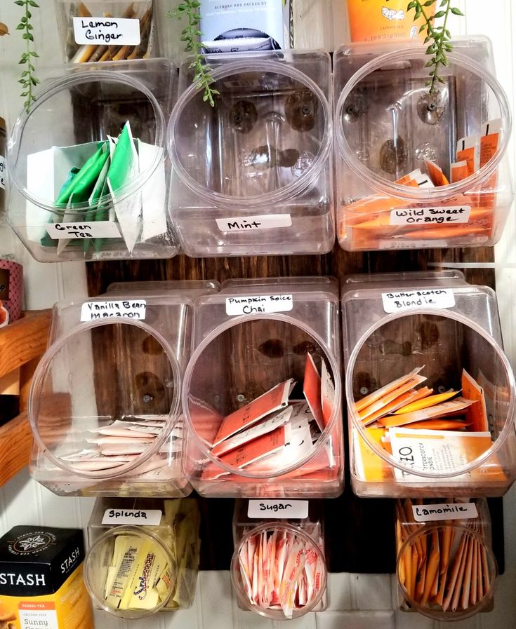 several plastic containers filled with different types of vegetables and fruits in them on the shelf next to each other