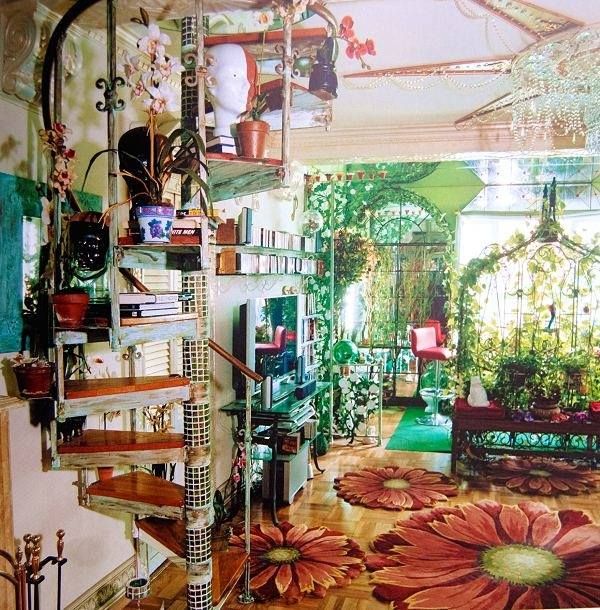 a living room filled with lots of furniture and flowers on the floor next to a window