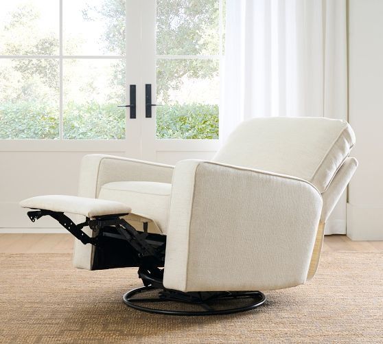 a white recliner chair sitting in front of a window