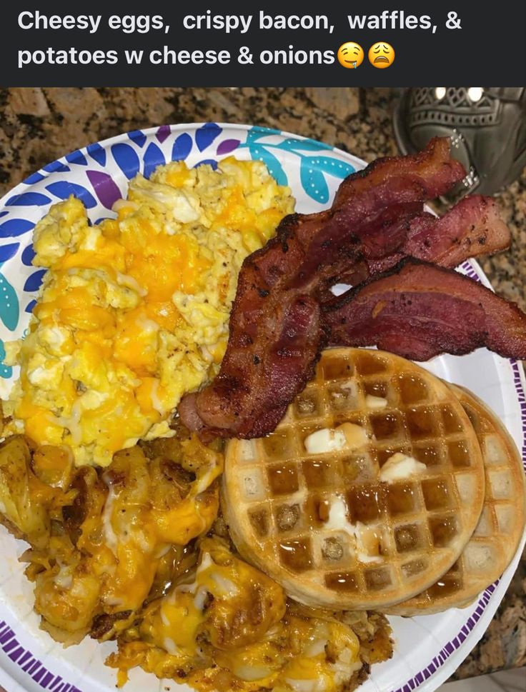 a plate with bacon, eggs and waffles on it