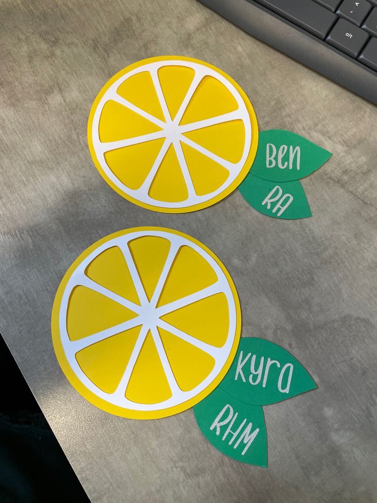 two slices of lemon sitting next to each other on top of a table near a keyboard