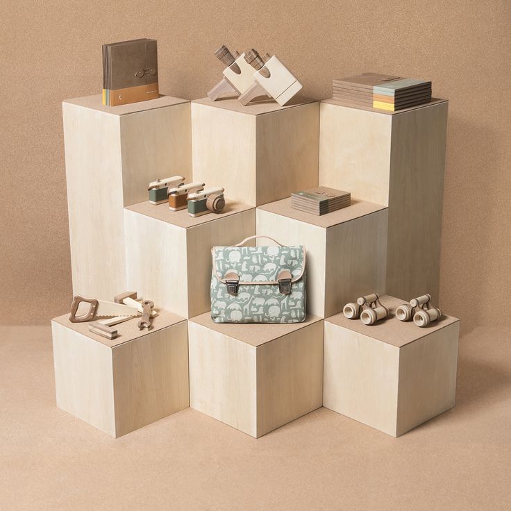 several cubes stacked on top of each other with various items sitting on the floor