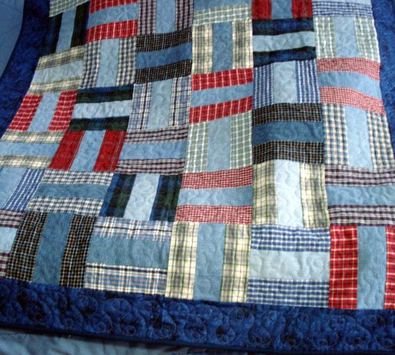 a blue and red quilt on top of a bed