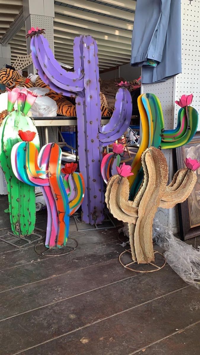 colorful cactus sculptures are on display in a store