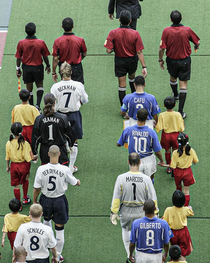 a group of soccer players walking onto the field