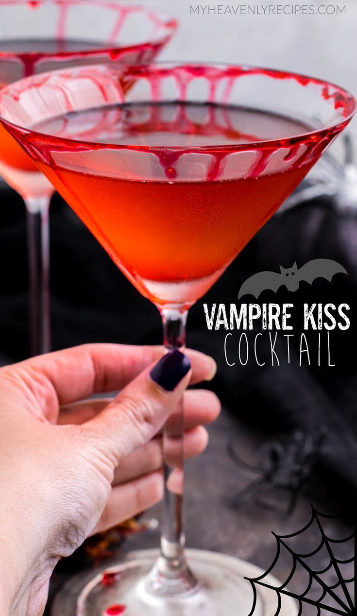 a hand holding a cocktail glass filled with vampire kiss cocktail