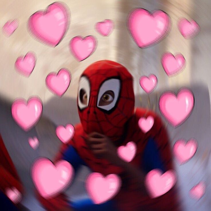 a man in a spider suit surrounded by hearts