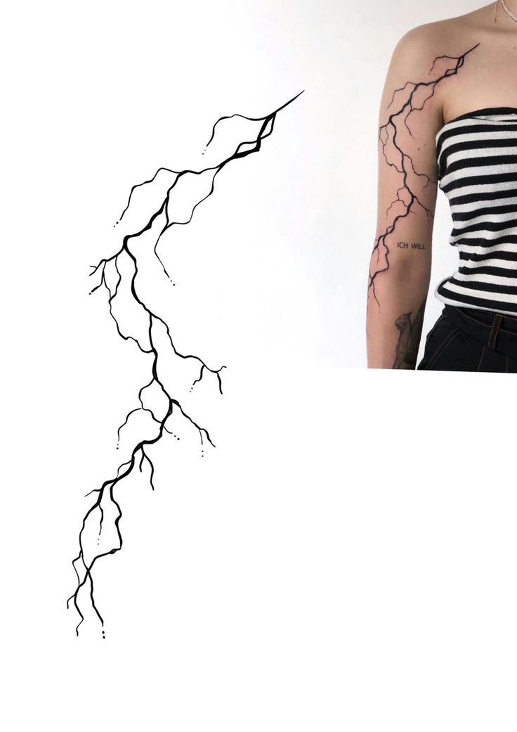 a woman with tattoos on her arm is standing in front of a white wall and lightning bolt