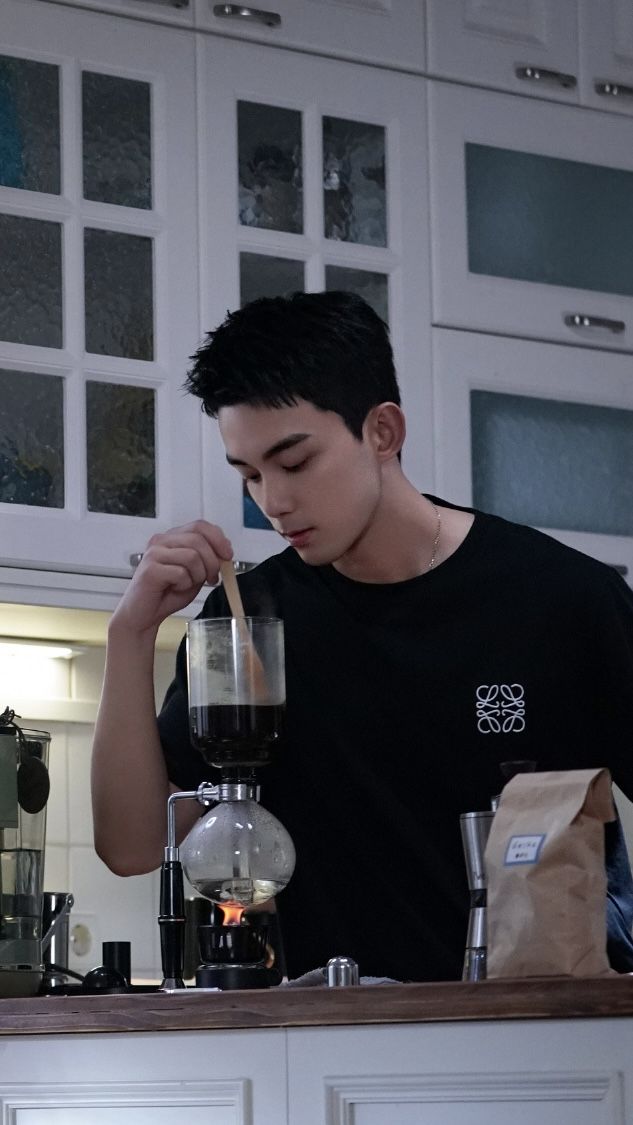 a man standing in front of a coffee maker