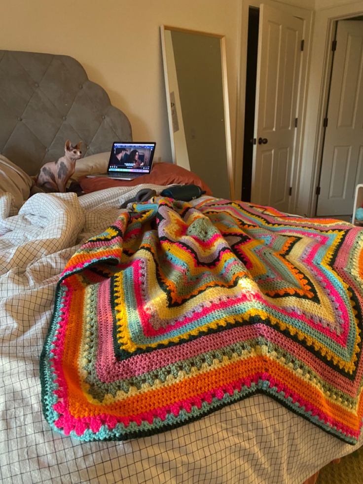 a bed with a laptop on top of it