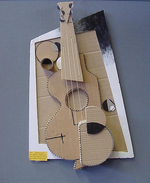 a cardboard cut out of a guitar on top of a table