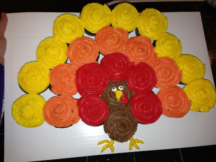 a turkey made out of cupcakes sitting on top of a sheet of paper