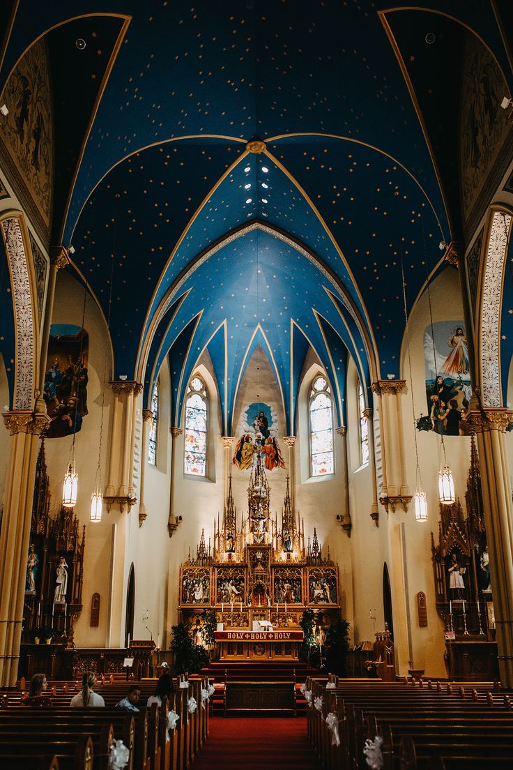 the inside of a church with pews and stained glass windows