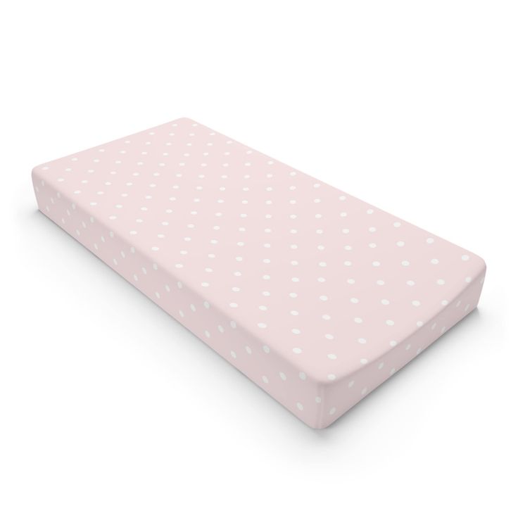 a pink mattress with white polka dots on it