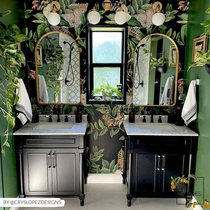 a bathroom with green walls and floral wallpaper