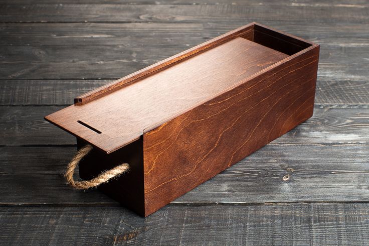 a wooden box with rope tied to it