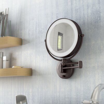 a bathroom mirror mounted to the side of a wall