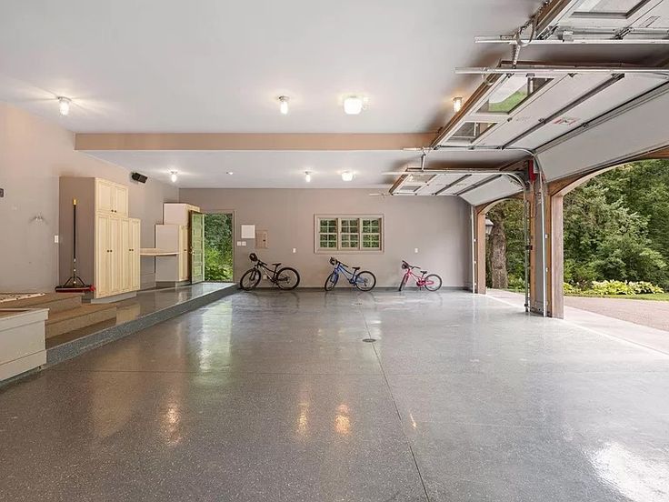 an empty garage with two bikes parked in it