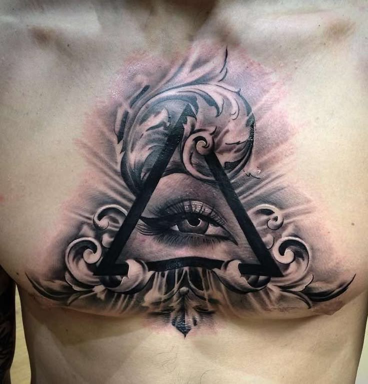 a man with an all seeing eye tattoo on his chest is shown in this image