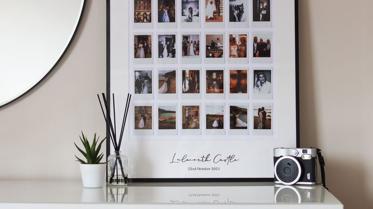 a white table topped with a framed photo next to a plant and a small camera