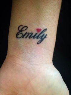 a small wrist tattoo with the word envy on it