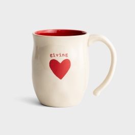 a white coffee mug with a red heart on the front and words flying above it