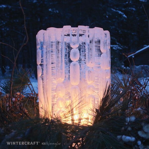 an ice block is lit up in the snow