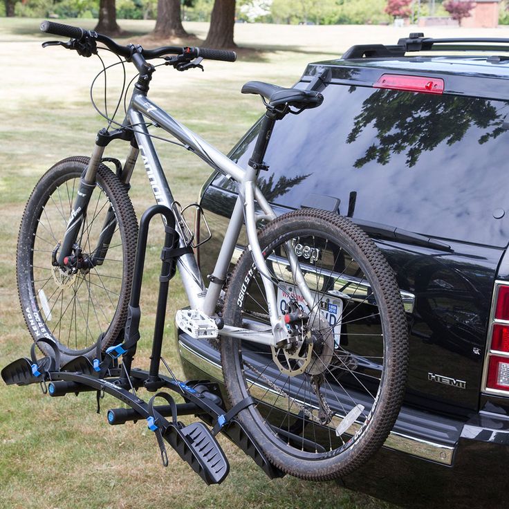 a bike is attached to the back of a car