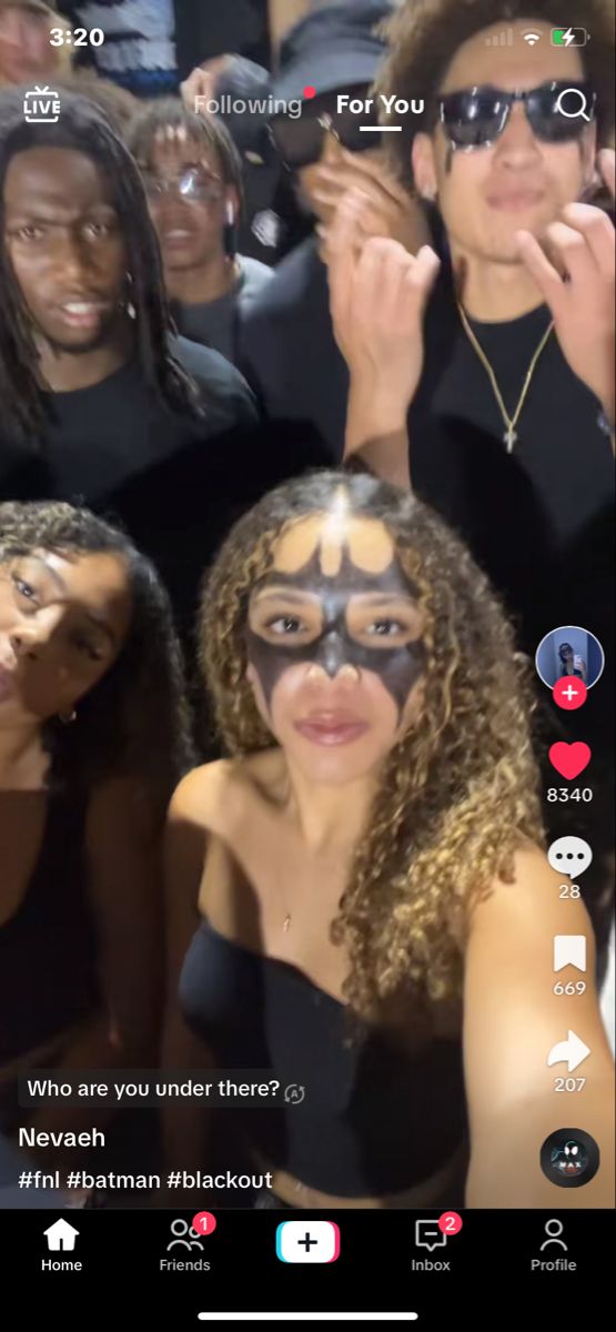 two girls with face paint on their faces and one girl has her hands in the air