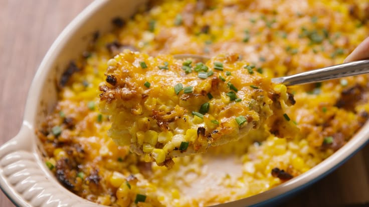 a person is scooping some food out of a casserole dish with a spoon