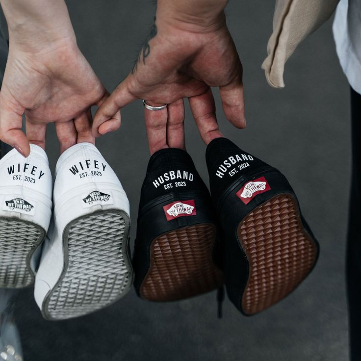 three people holding their shoes in the shape of they are wearing slippers that say wife and husband