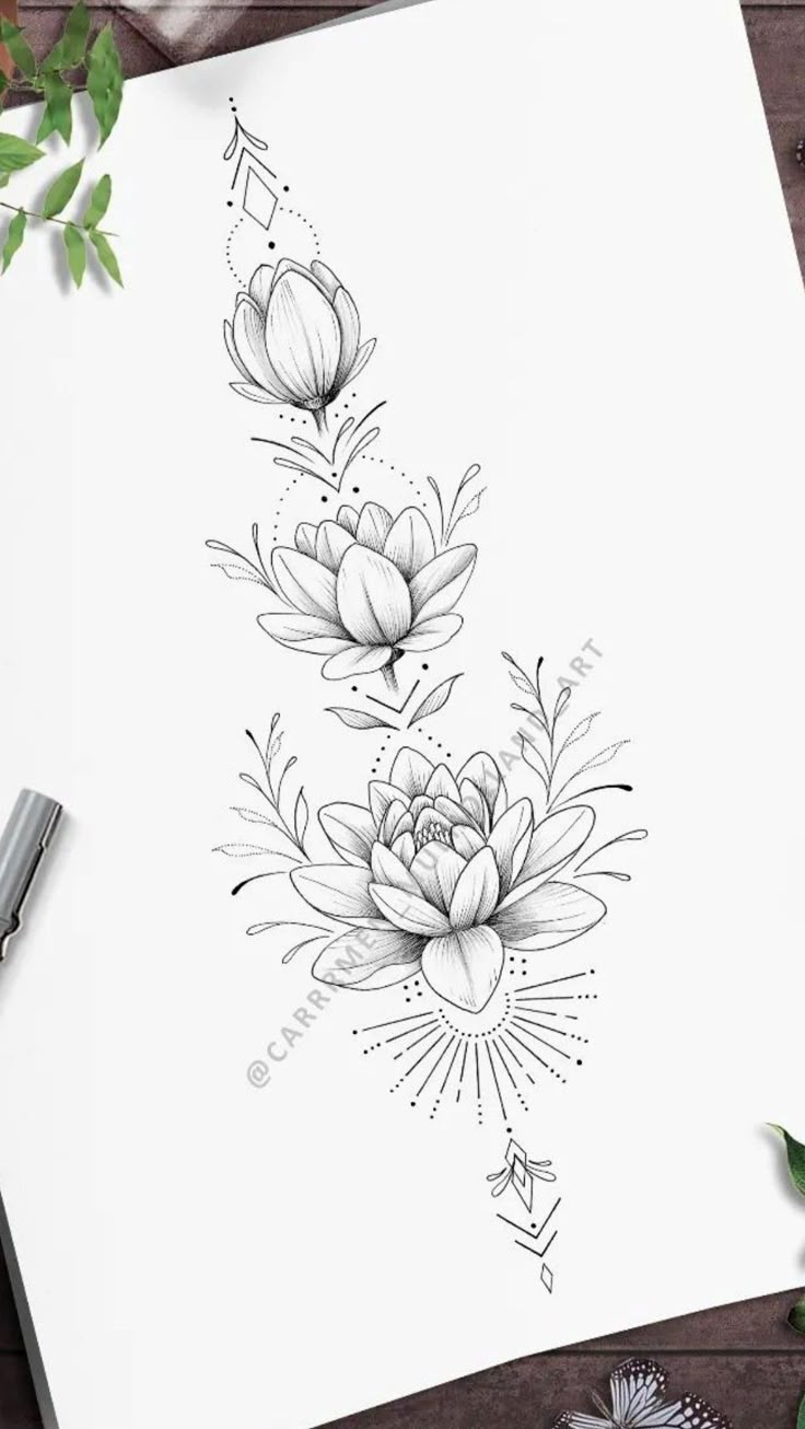 an ink drawing of flowers on paper next to some scissors and pencils, with the title