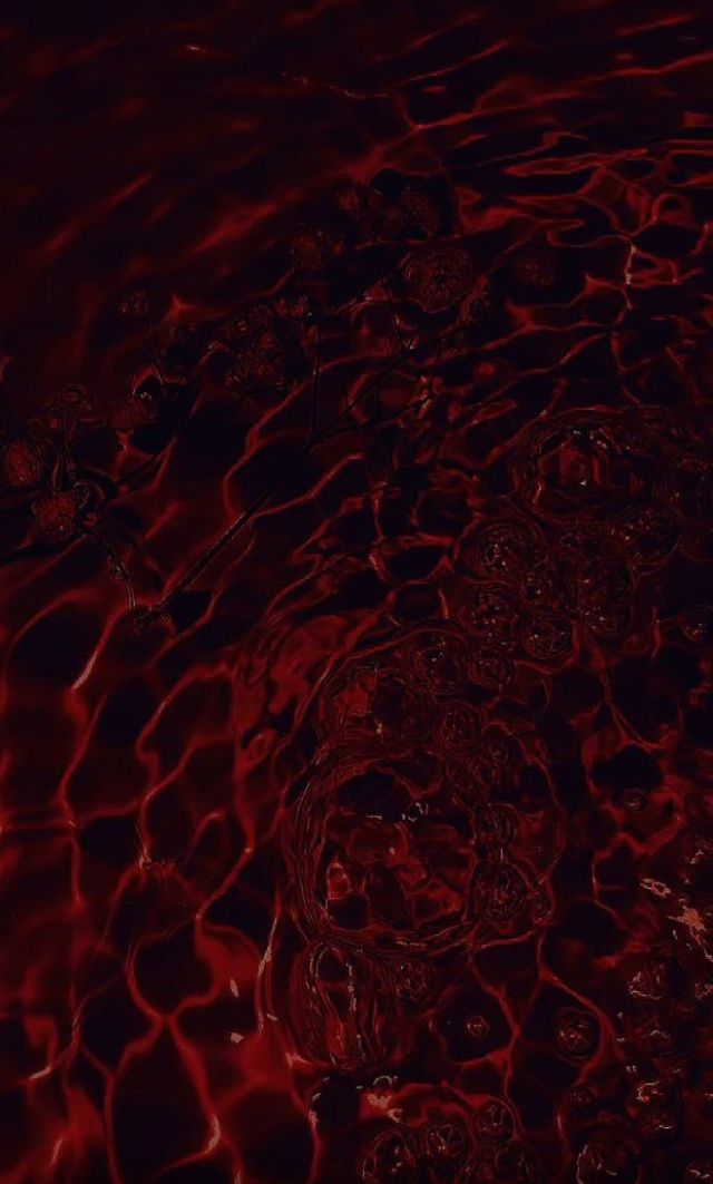 red water ripples on the surface of a body of water with dark, reddish hues