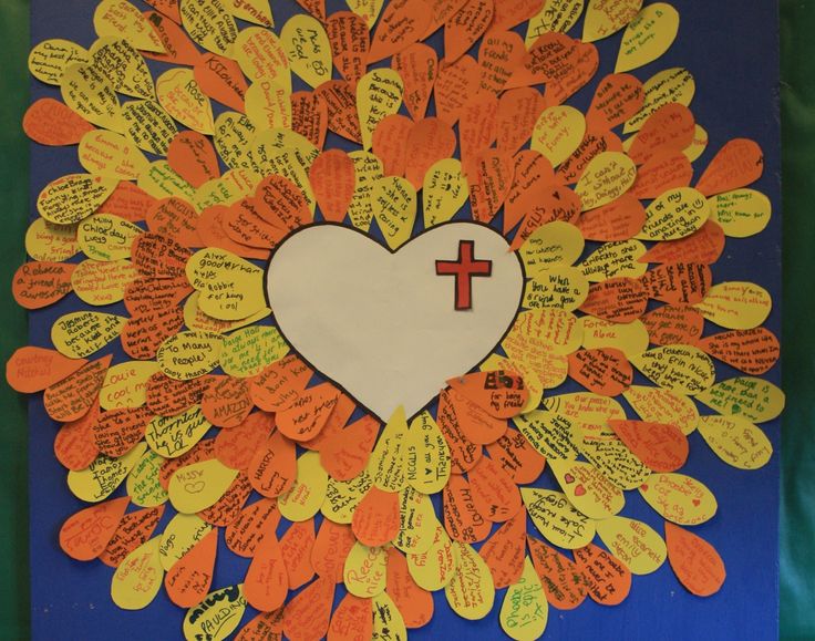 a bulletin board with hearts and a cross in the shape of a sunburst