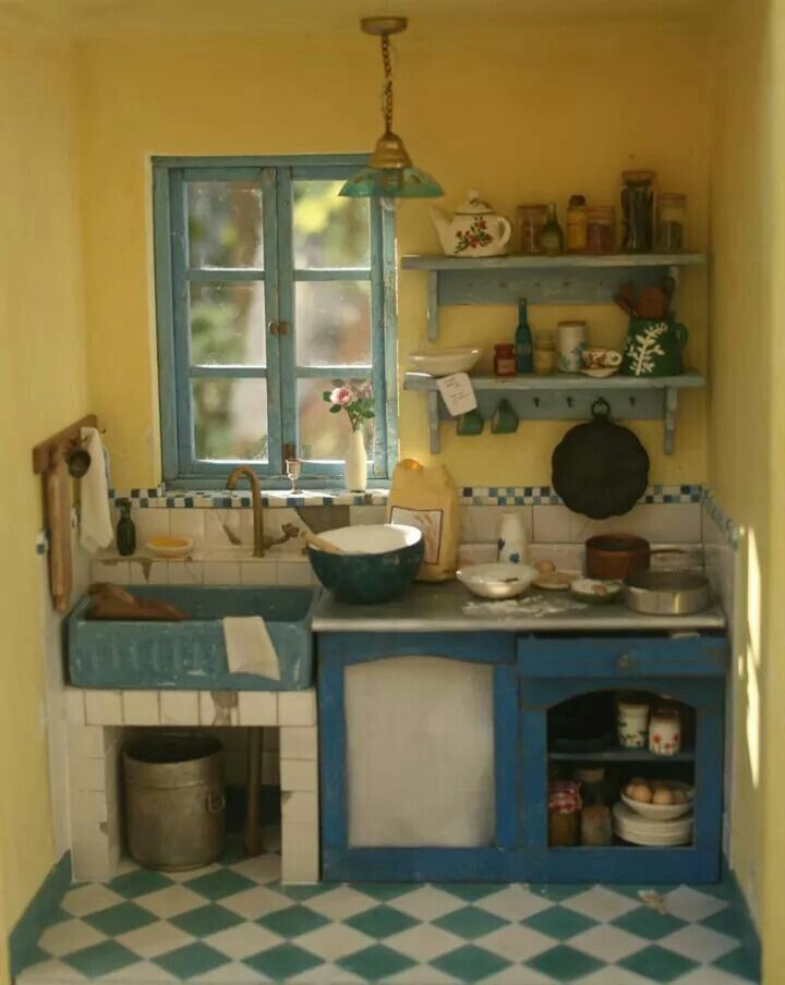 an old fashioned kitchen with blue and white checkerboard flooring on the walls