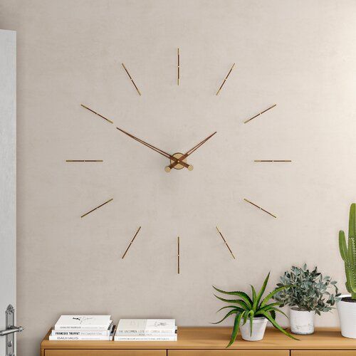 a clock on the wall above a dresser with potted plants and books next to it