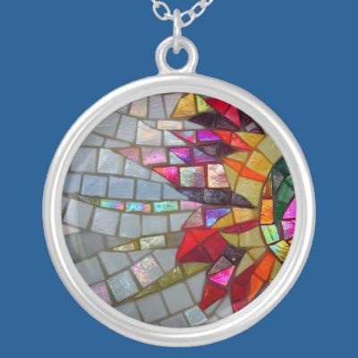 a colorful mosaic design on a silver plated necklace