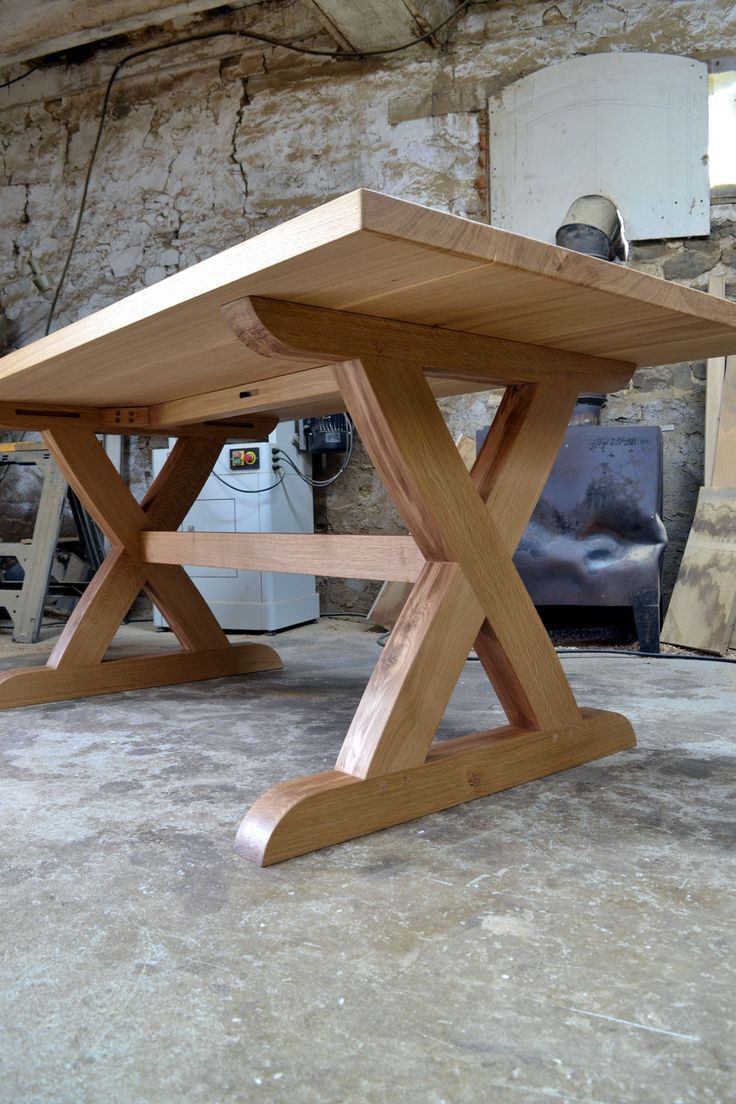 a wooden table sitting on top of a cement floor