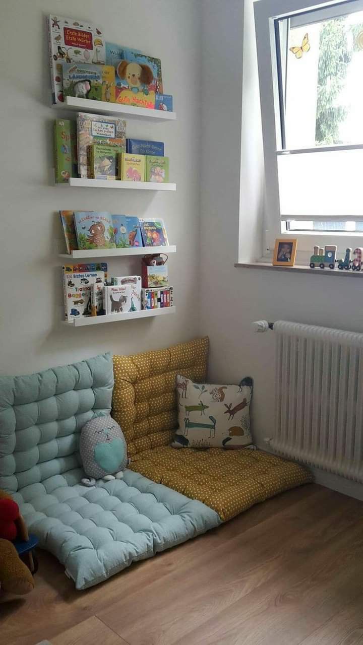 a child's room with bookshelves and toys on the wall, including a couch