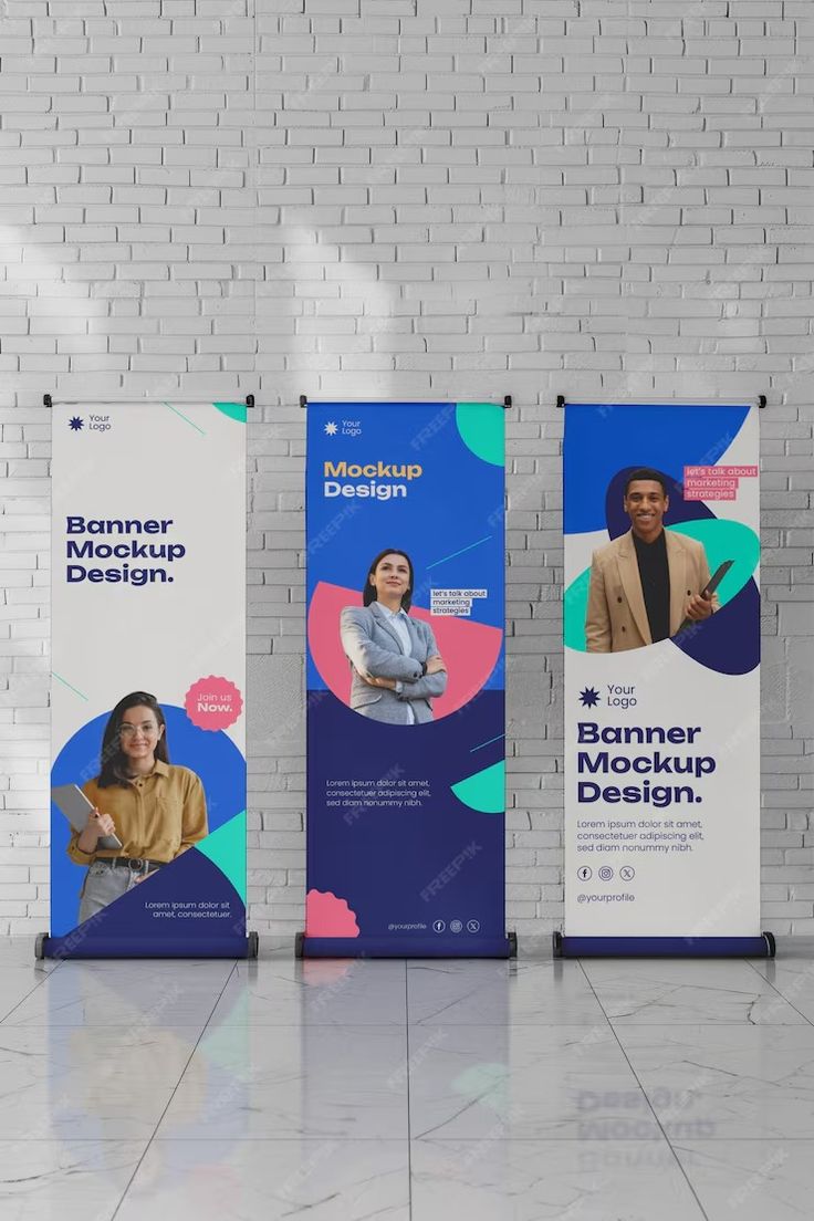 three roll up banners on the side of a white brick wall