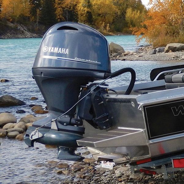 two motor boats are parked on the shore