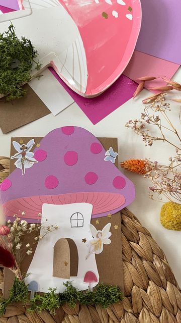 there is a paper mushroom on the table with flowers and other items around it,