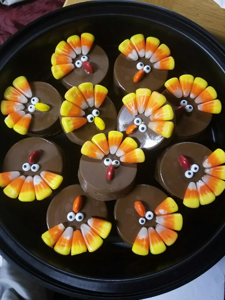 a pan filled with cupcakes decorated like turkeys