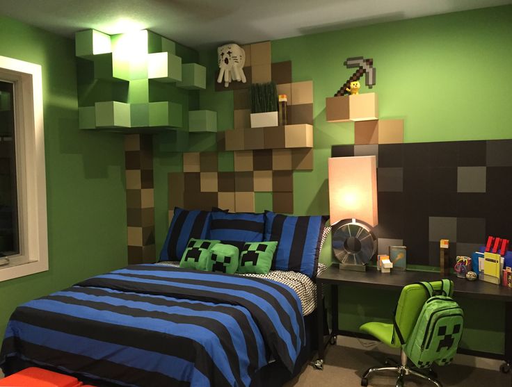 a bedroom decorated in green and blue with minecraft decor on the wall above the bed