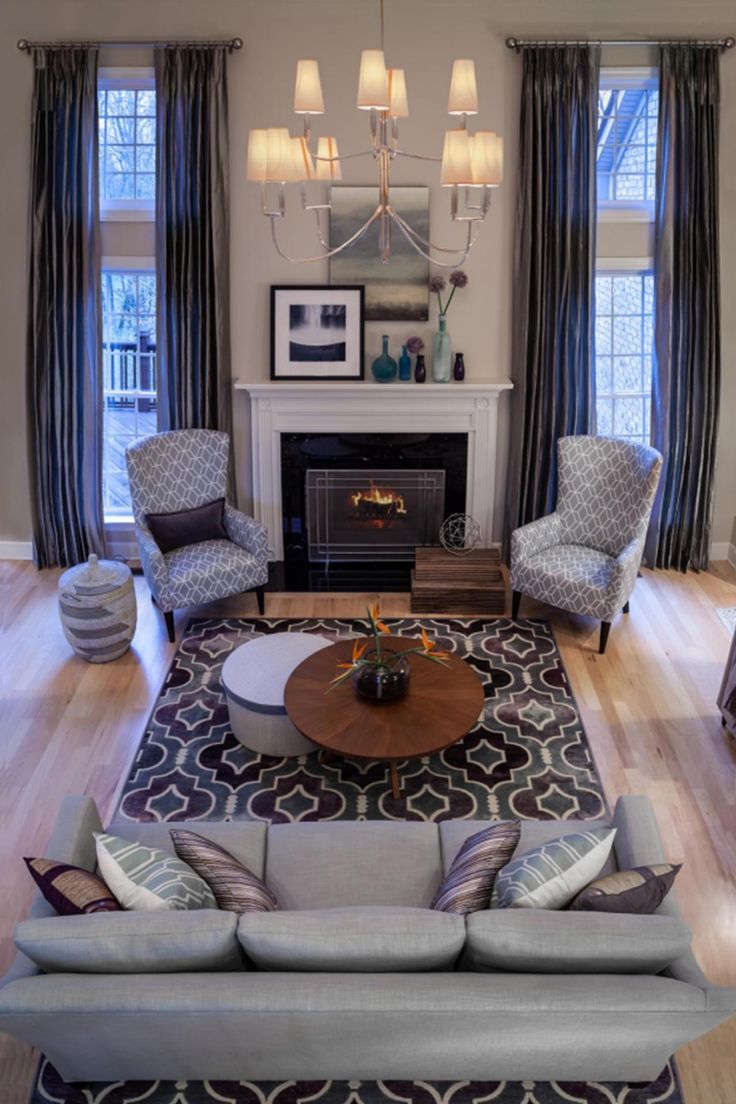 a living room filled with furniture and a fire place in the middle of a room