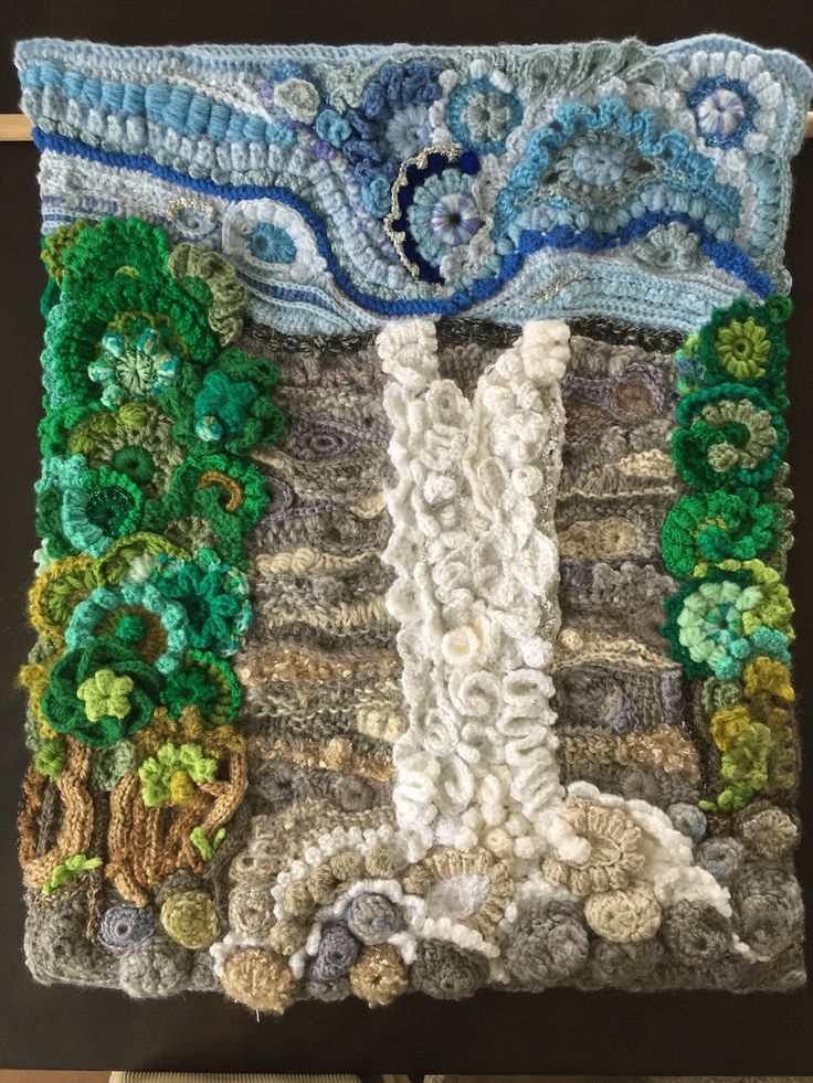 a piece of art made out of crochet and yarn with an image of a waterfall