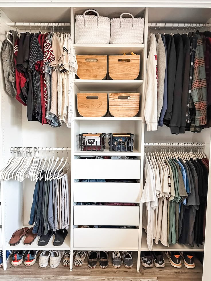 a white closet filled with lots of clothes and baskets on top of it's shelves